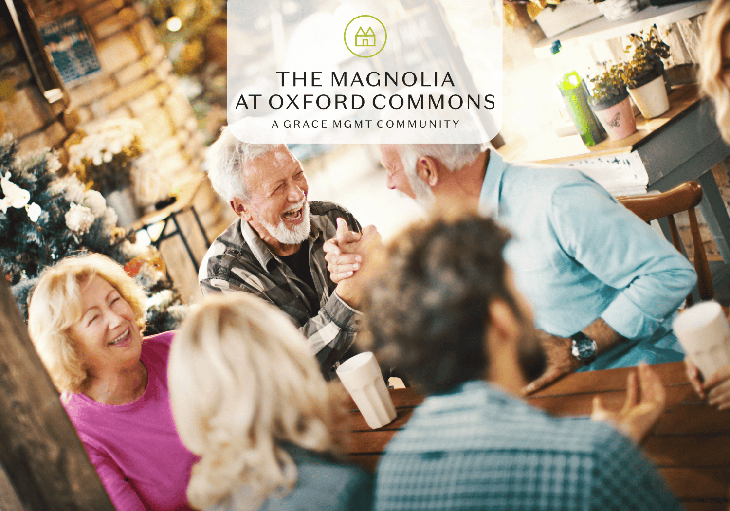 Magnolia - The Magnolia at Oxford Commons older adults sitting at a table laughing